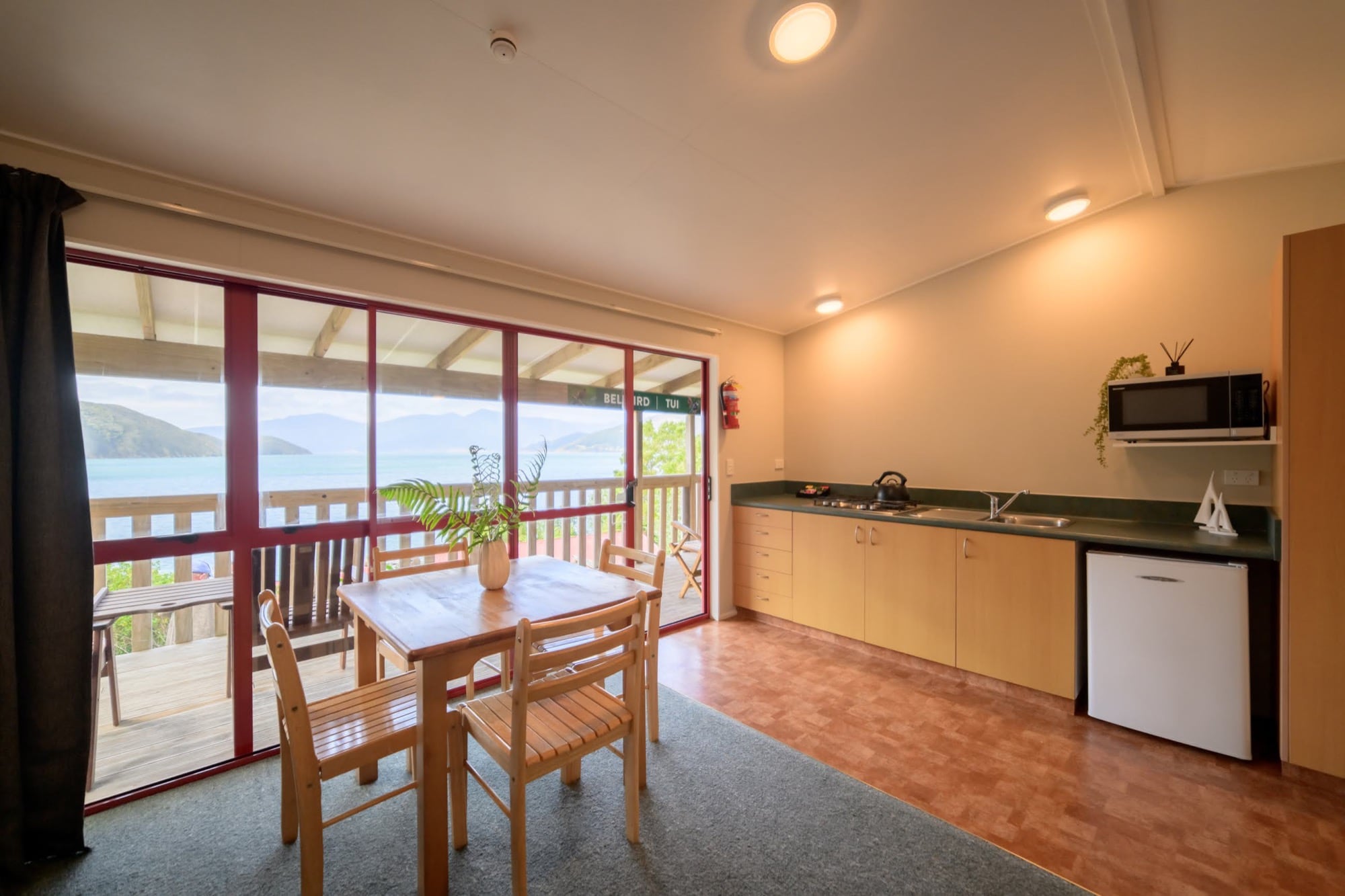Bellbird living room and kitchenette, opening onto the deck