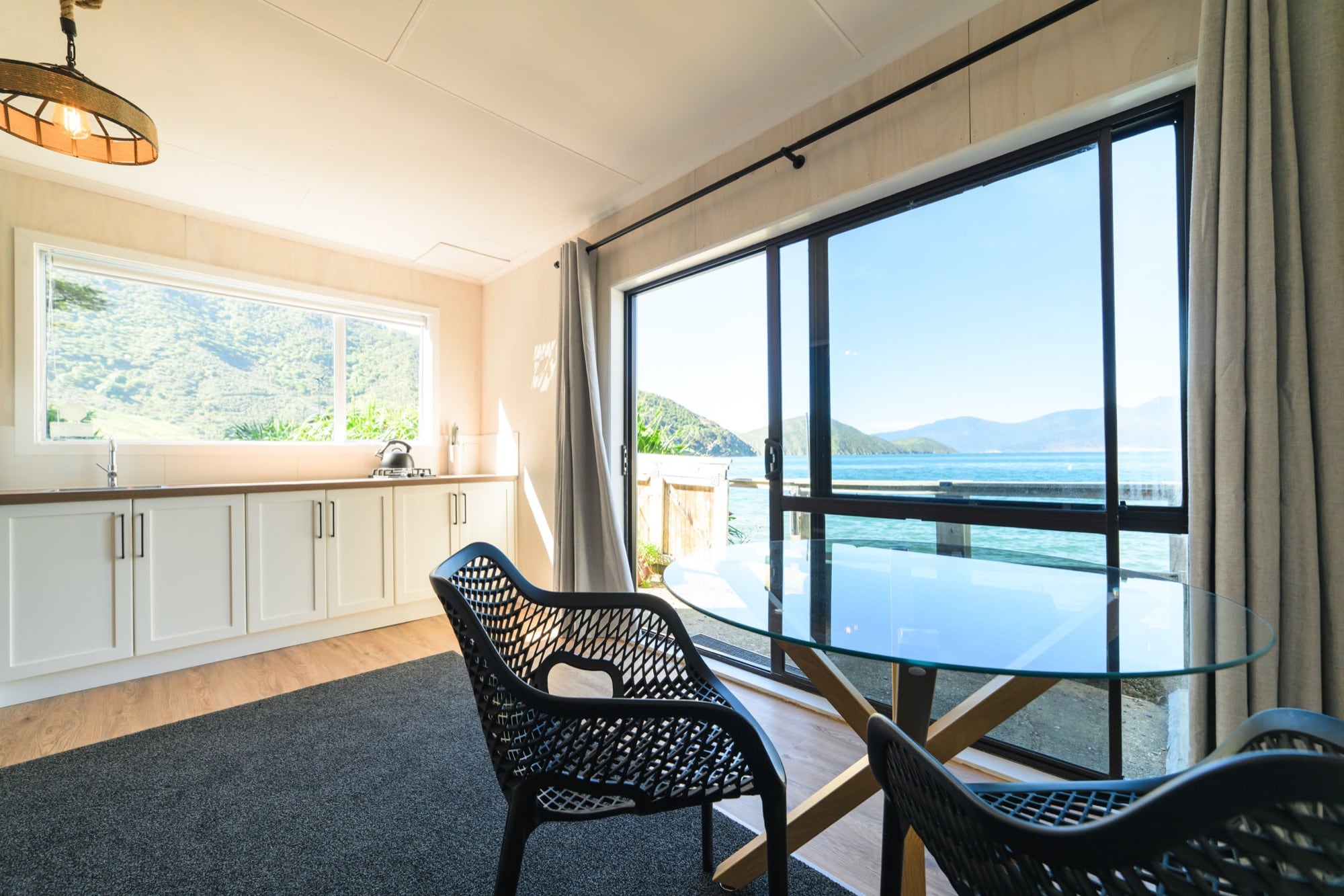 Kitchen and dining in the one-bedroom unit, looking onto the bay