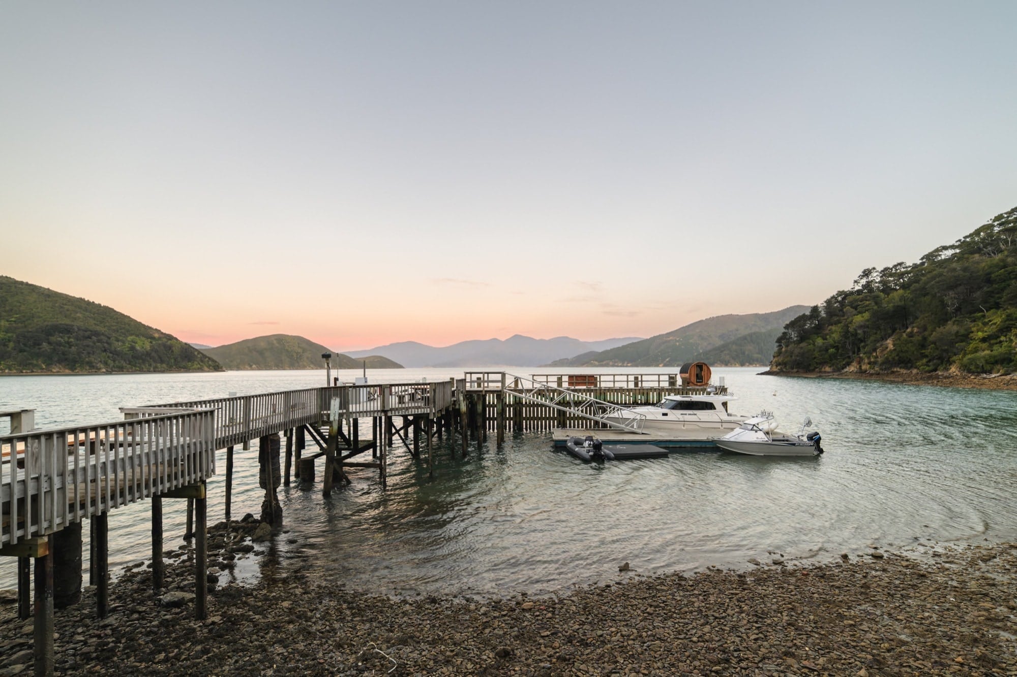 The Te Rawa jetty at dusk, the water still